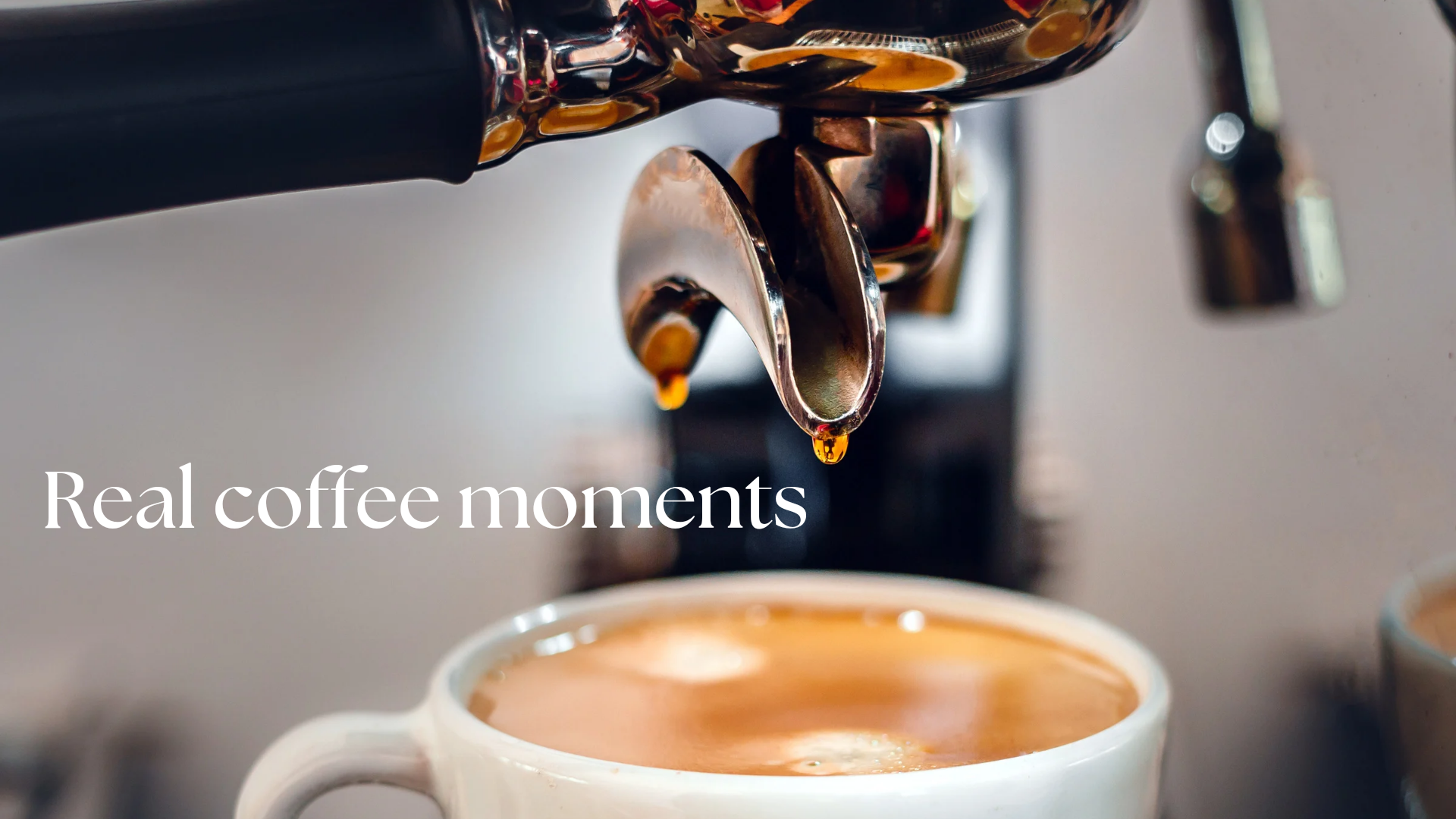 Close-up of espresso machine pouring coffee into a white cup with “Real coffee moments” text