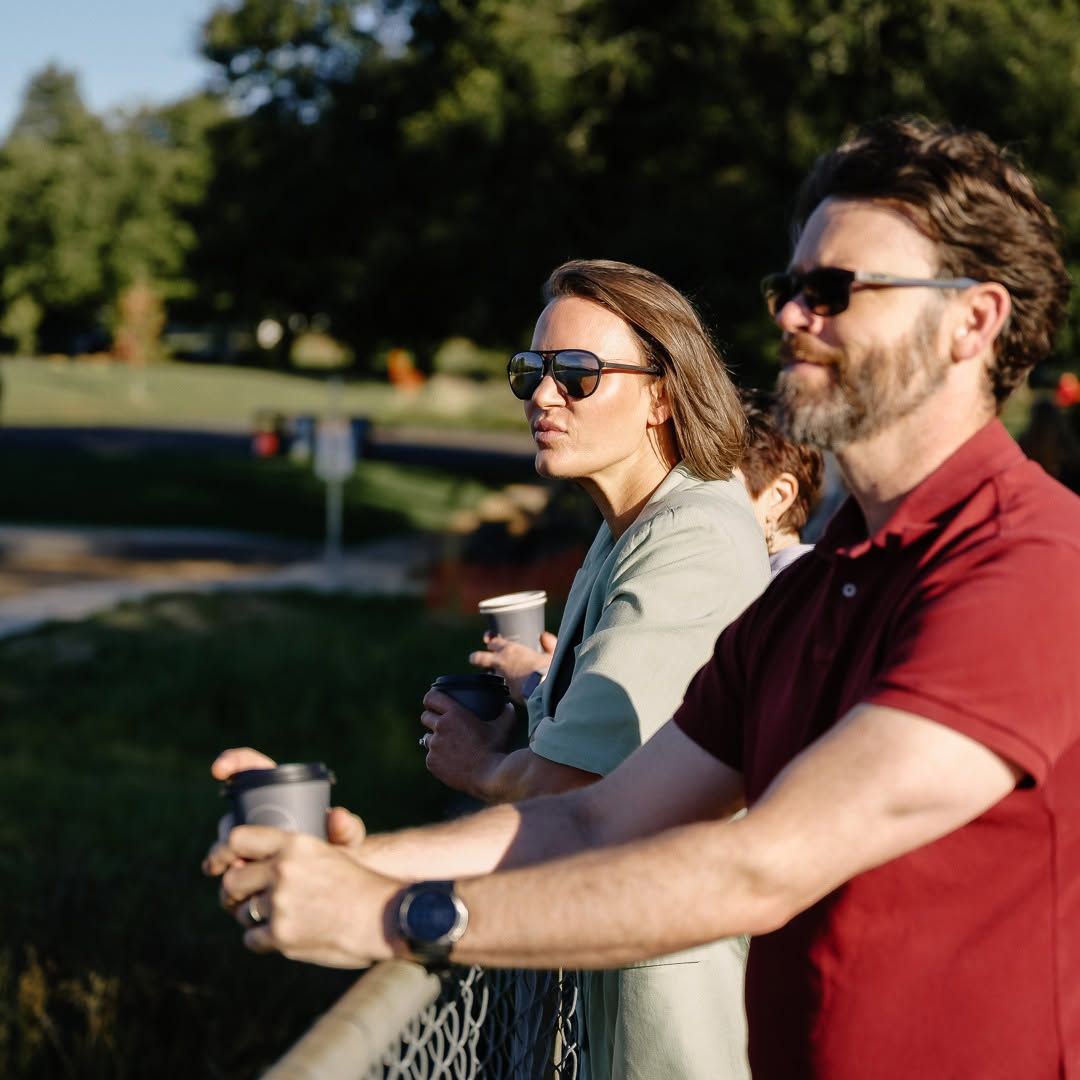 Two People in Sunglasses Holding Mugs Outdoors in a Sunny Park — Lakeview Luxury Retreat in Canobolas, NSW