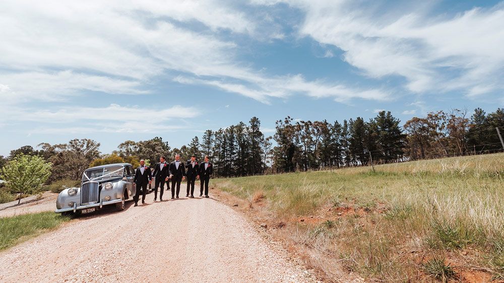 A Group of Men Standing Next to a Car on a Dirt Road — Lakeview Luxury Retreat in Canobolas, NSW