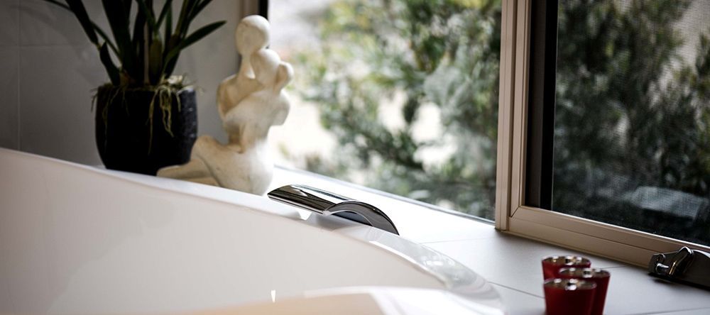 A Bathtub is Sitting on a Window Sill Next to a Window — Lakeview Luxury Retreat in Canobolas, NSW