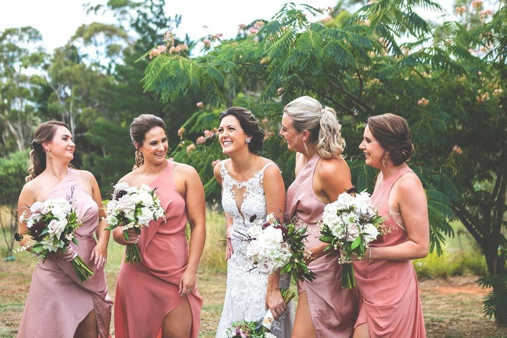 A Bride and Her Bridesmaids Are Standing Next to Each Other in a Field — Lakeview Luxury Retreat in Canobolas, NSW