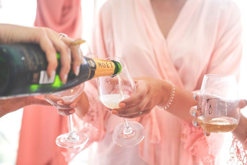 A Group of Women Are Pouring Champagne Into Glasses — Lakeview Luxury Retreat in Canobolas, NSW