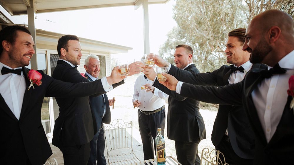 A Group of Men in Tuxedos Are Toasting With Champagne on a Porch — Lakeview Luxury Retreat in Canobolas, NSW