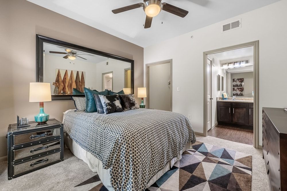 a bedroom with a large bed and a ceiling fan at Marquis on Lakeline in Cedar Park, TX.