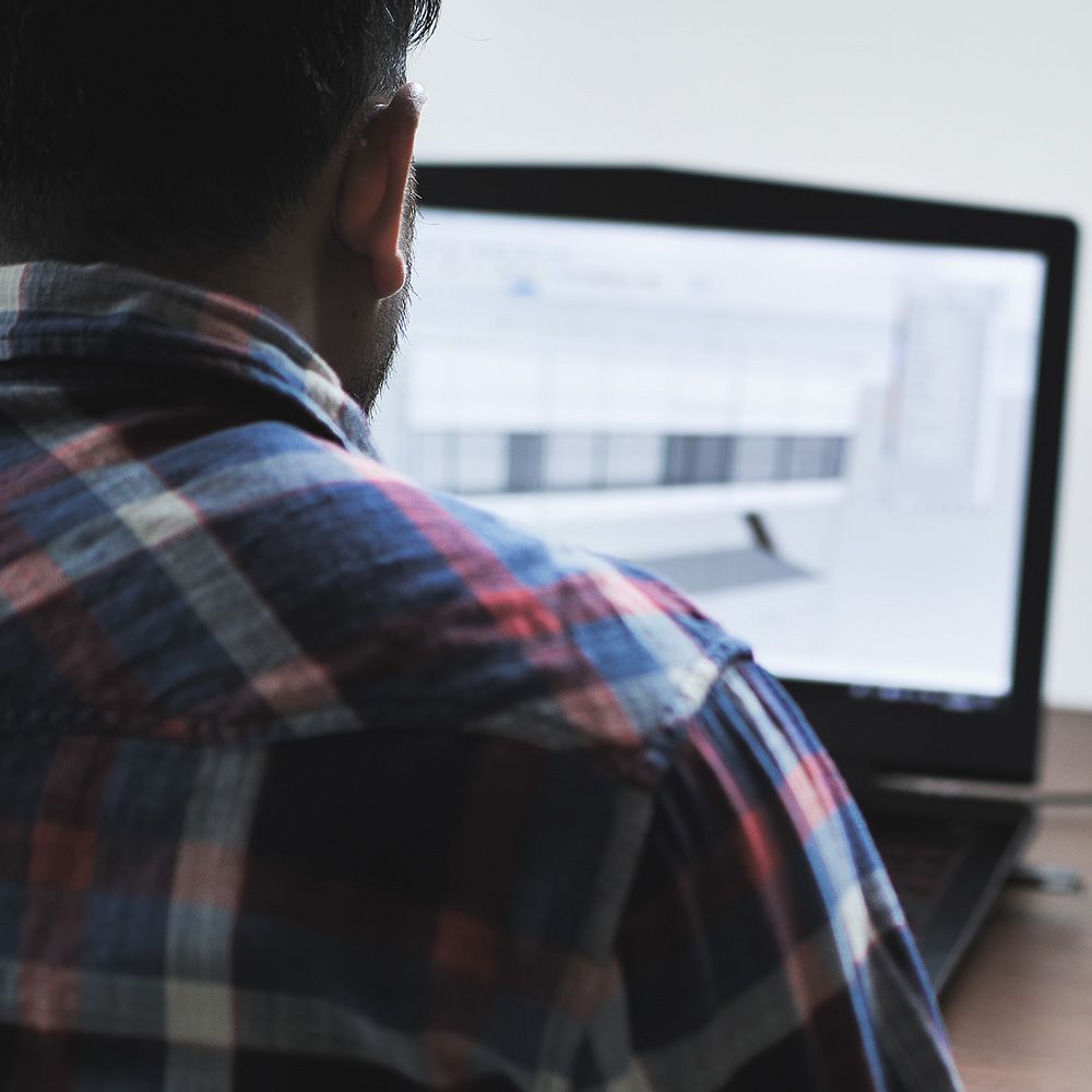 Man Using His Laptop — Mornington Peninsula, VIC — Carson Development Consultants Pty Ltd