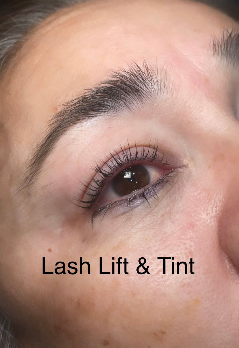 A close up of a woman 's eye with lash lift and tint.