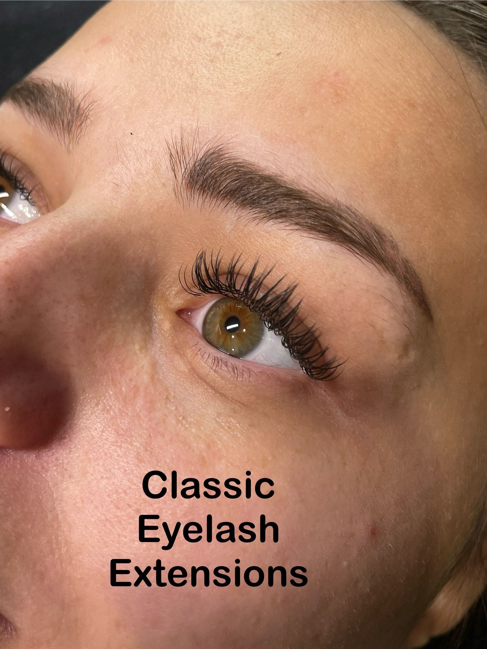 A close up of a woman 's eye with classic eyelash extensions.