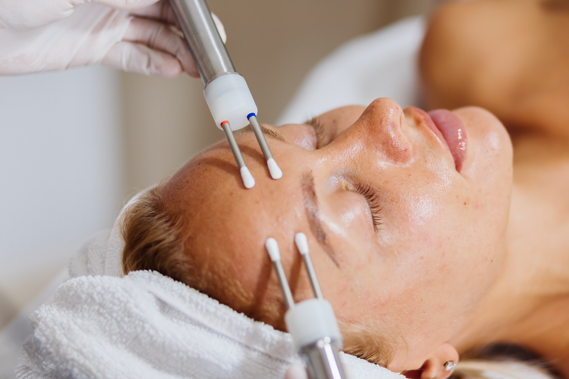 A woman is getting a facial treatment at a spa.