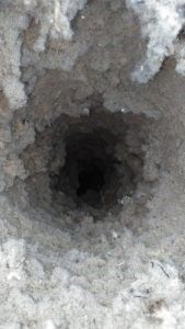 A close up of a hole in the ground.