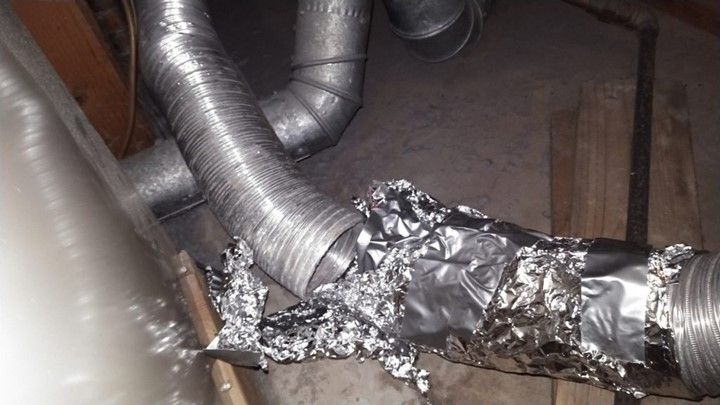 A close up of a metal pipe covered in aluminum foil.