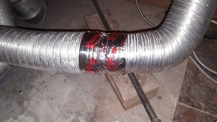 A close up of a metal pipe with duct tape on it.