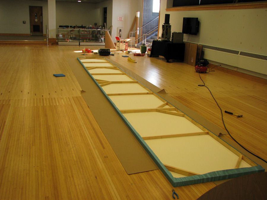 A wooden floor with a large canvas on it