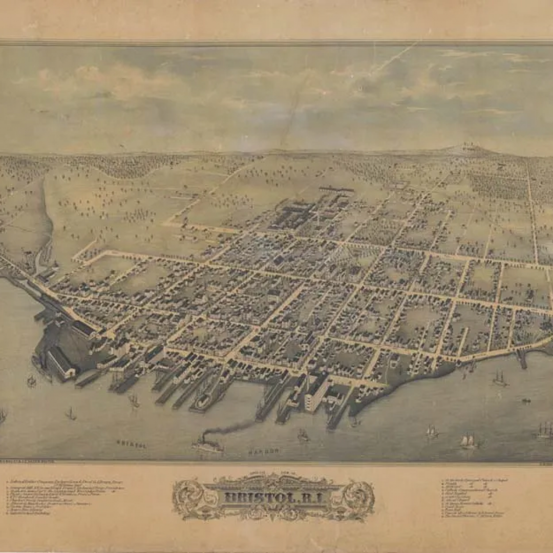 An aerial view of a city surrounded by water and mountains.