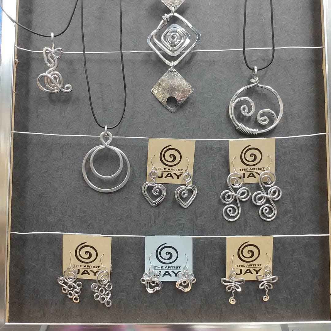 A display of jay jewelry including necklaces and earrings
