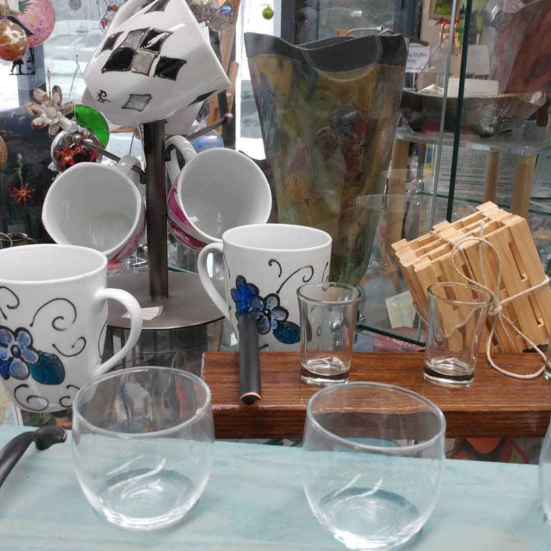 A table with a lot of cups and glasses on it