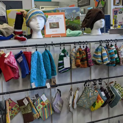 A bunch of hats and socks are hanging on a rack