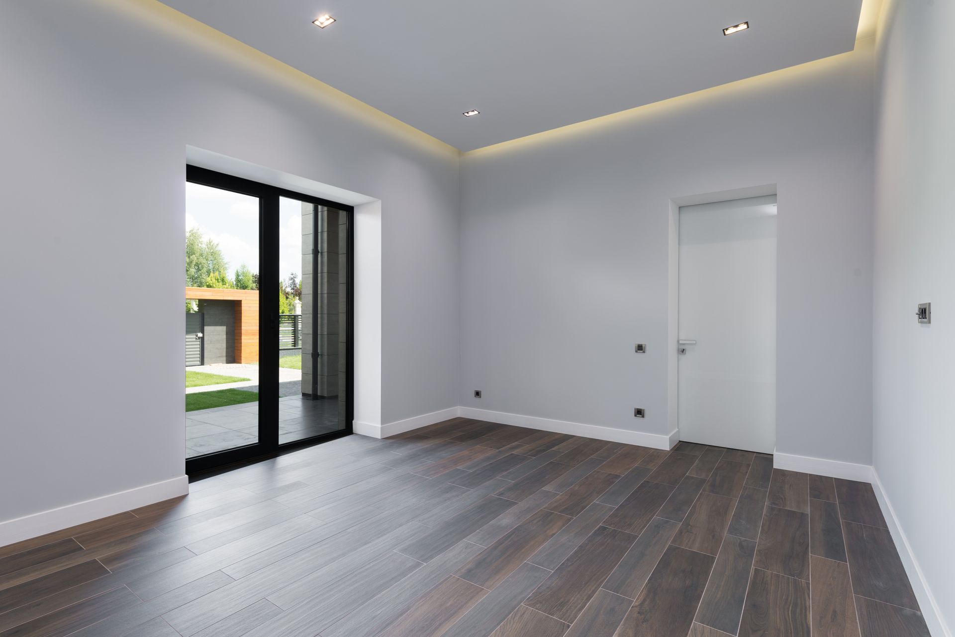 First-time buyer doormat by moving boxes and two people’s feet at a doorway