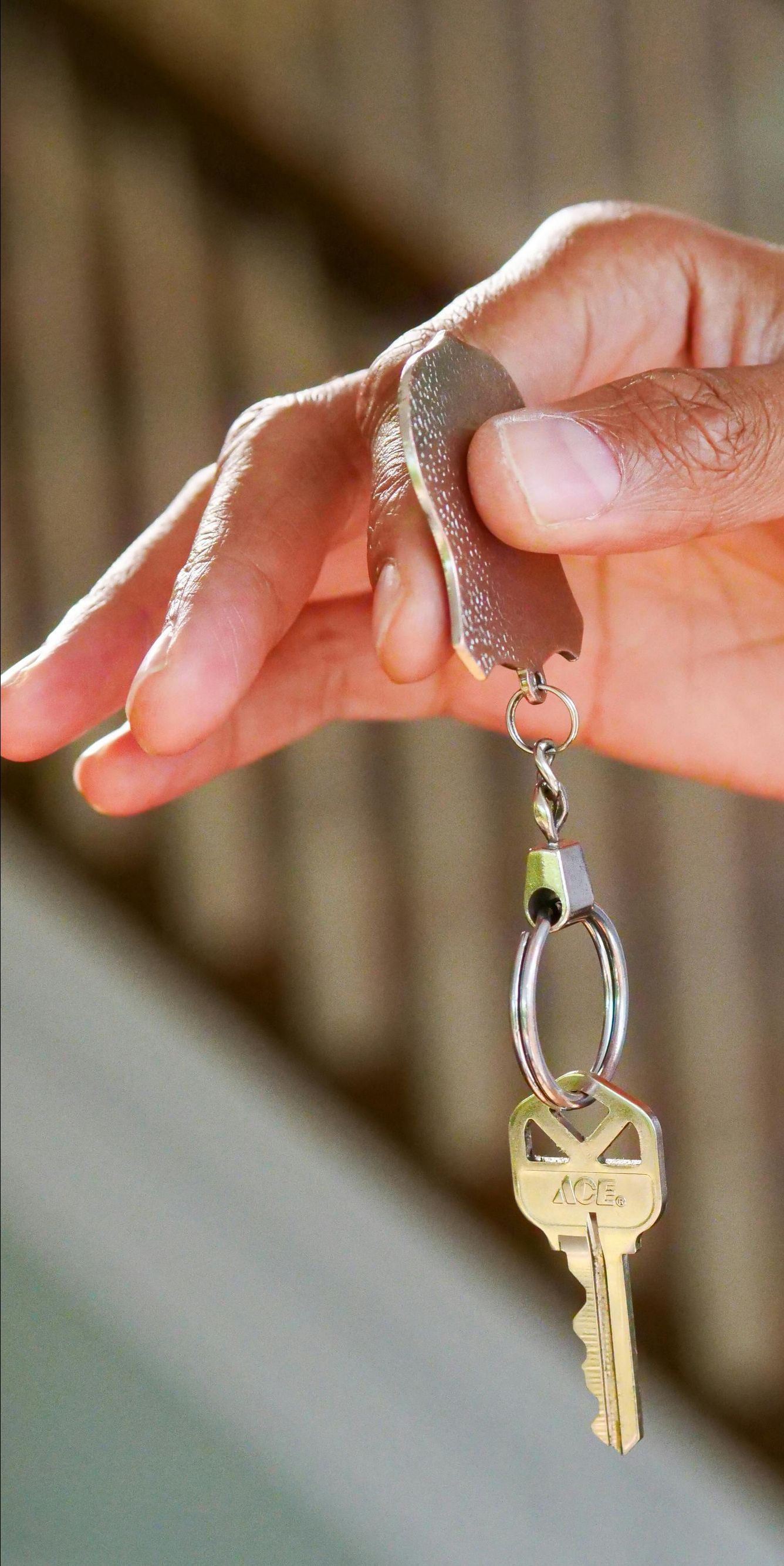 happy young couple welcoming in their new house showing the door keys at entrance door