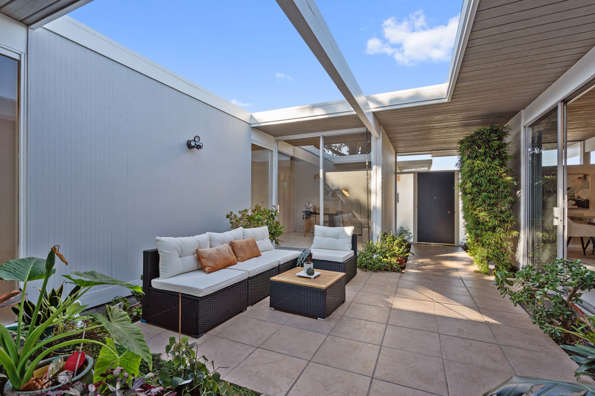 A patio with a couch and a table in a house