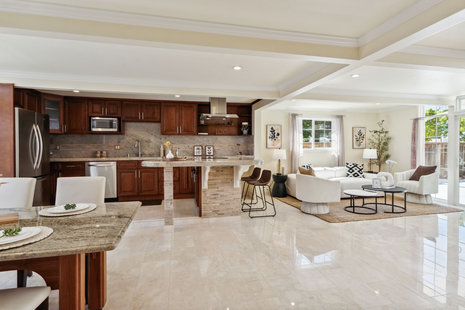 A living room with a kitchen , dining room , and a couch.