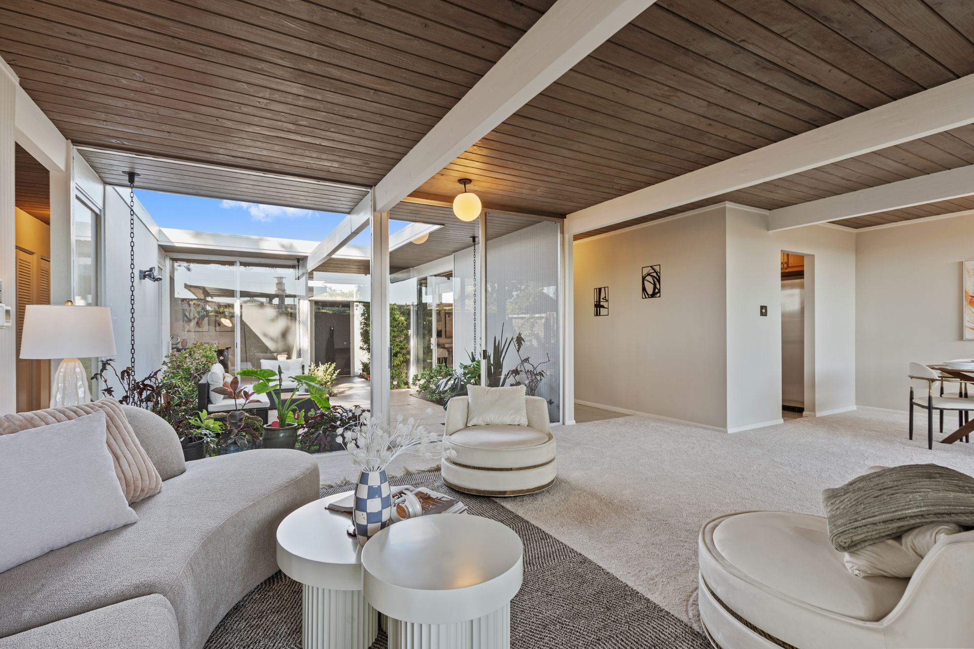 A living room with a couch , chairs and tables