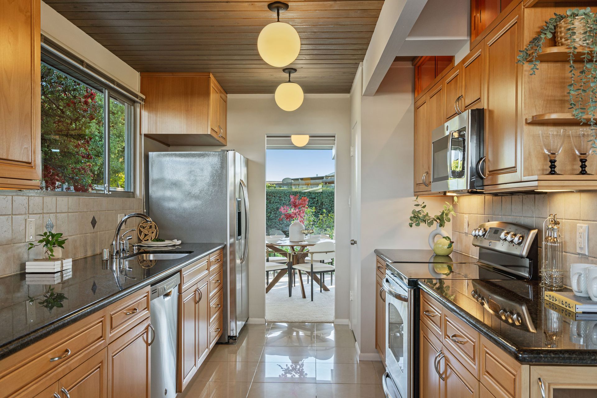 A kitchen with stainless steel appliances and wooden cabinets