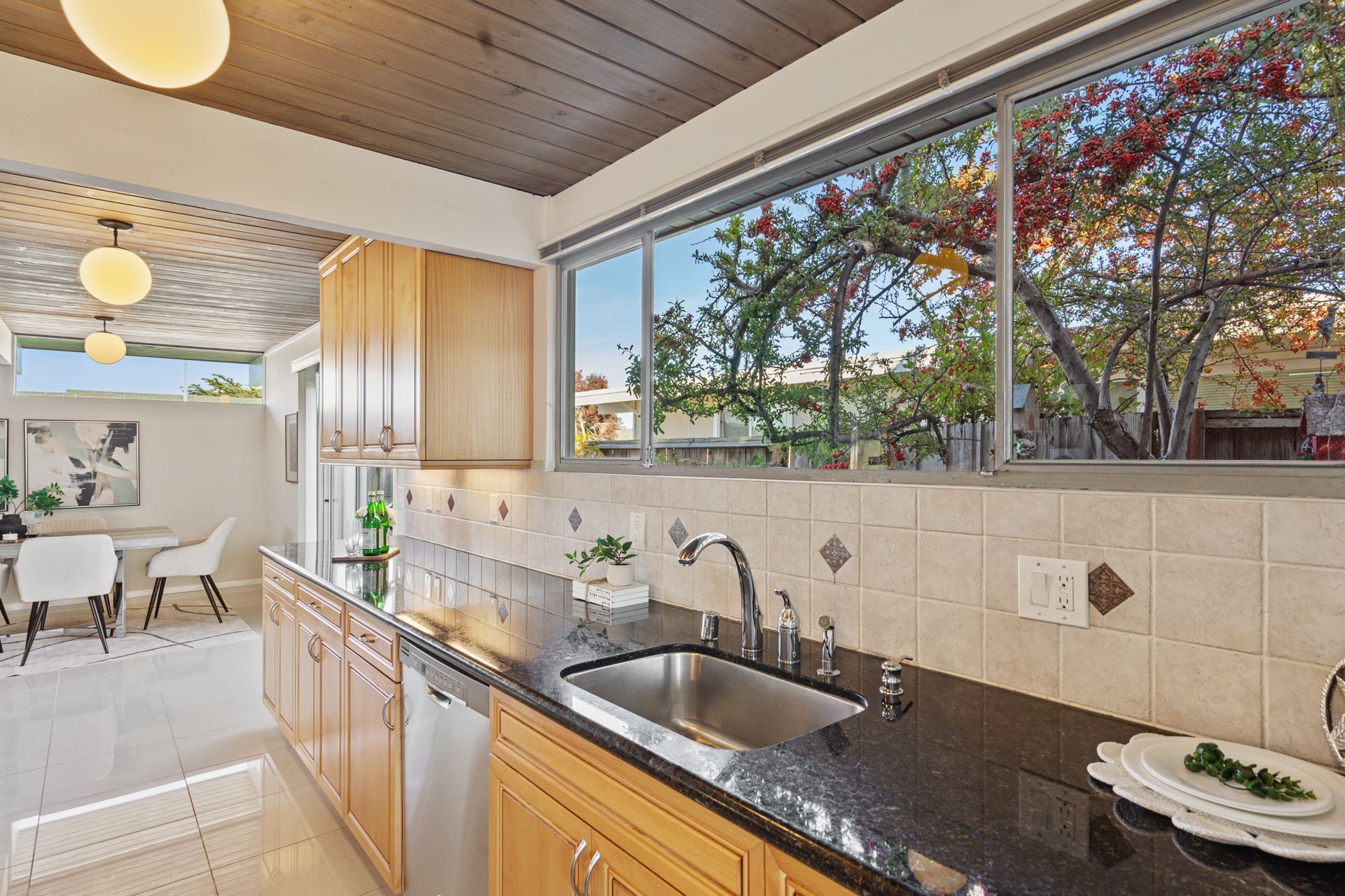 A kitchen with a sink and a large window