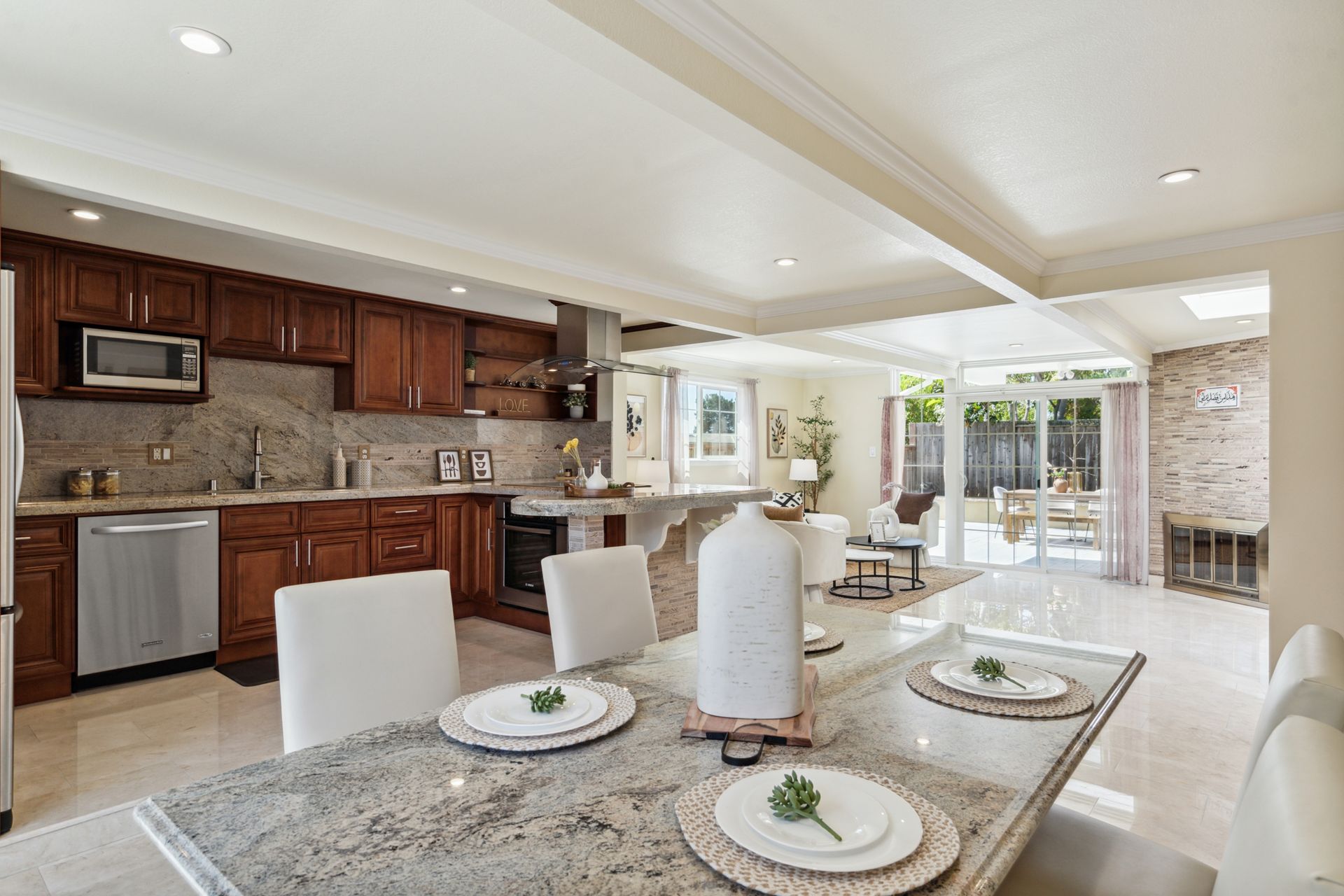 There is a dining table in the middle of the kitchen.