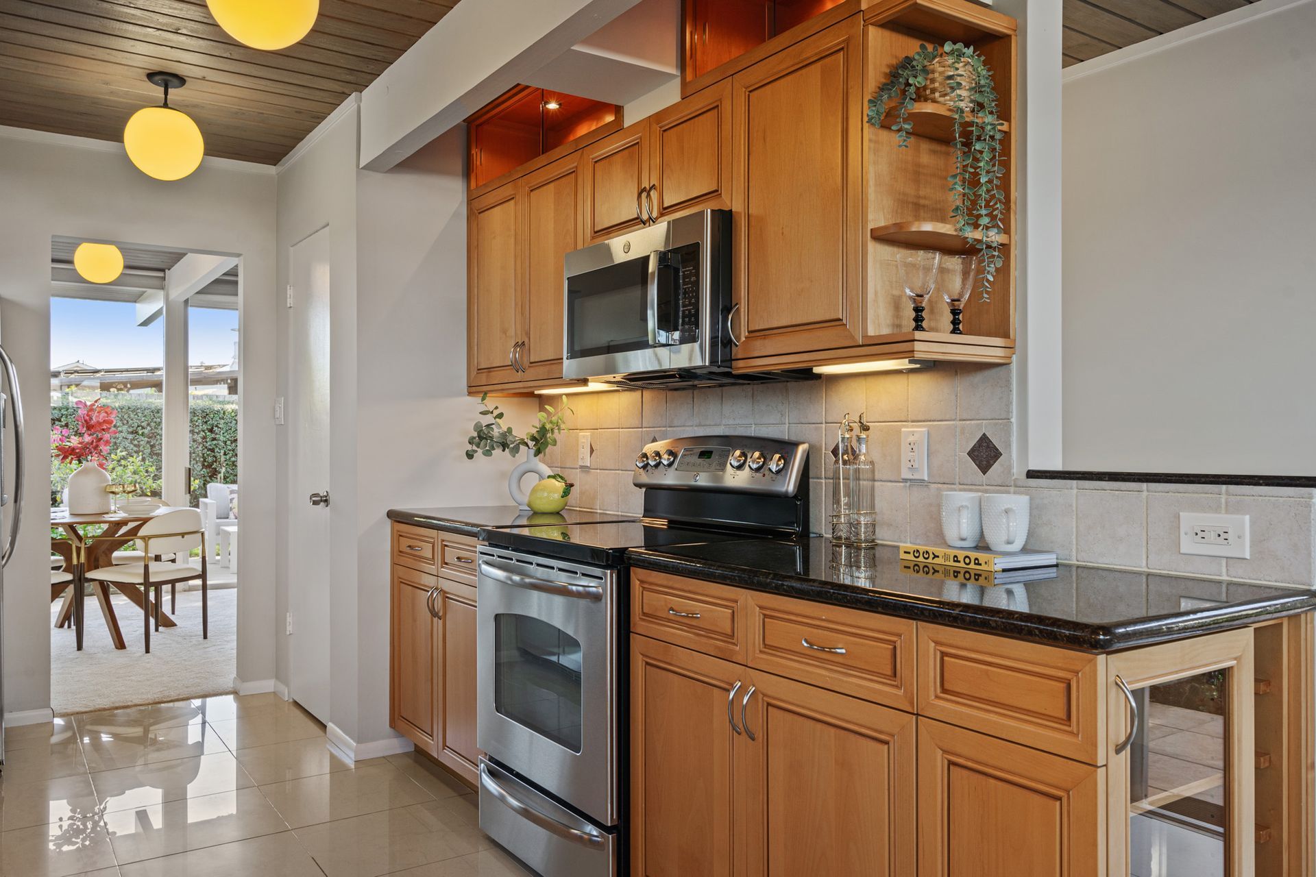 A kitchen with stainless steel appliances and wooden cabinets