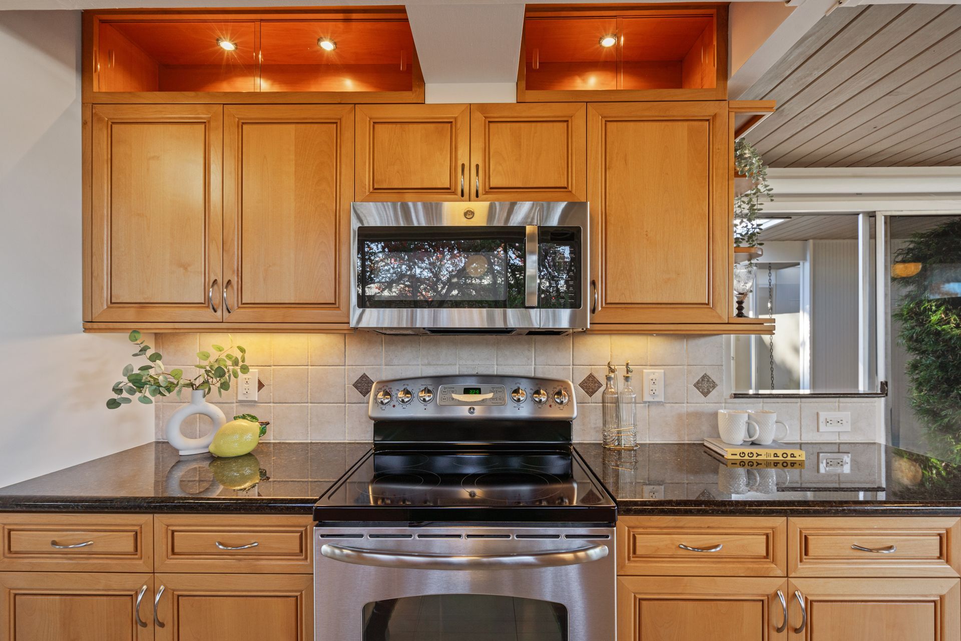 A kitchen with stainless steel appliances and wooden cabinets