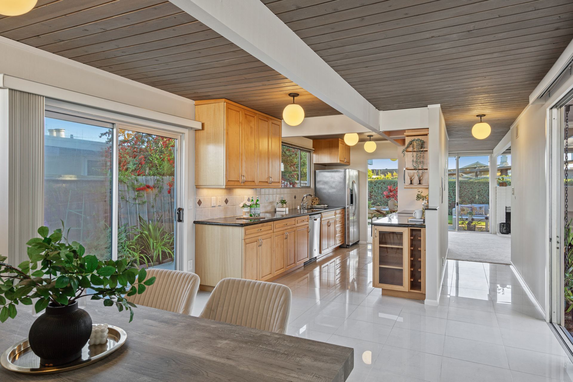A kitchen and dining room in a house with a table and chairs