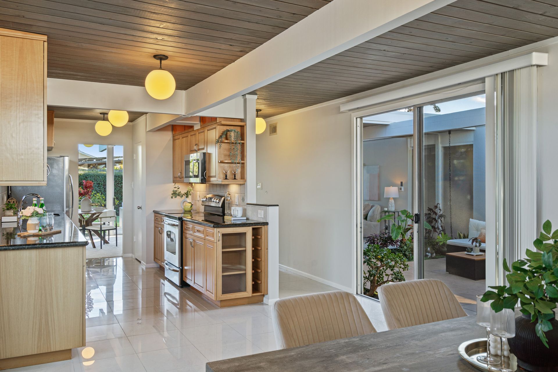 A kitchen and dining room in a house with sliding glass doors