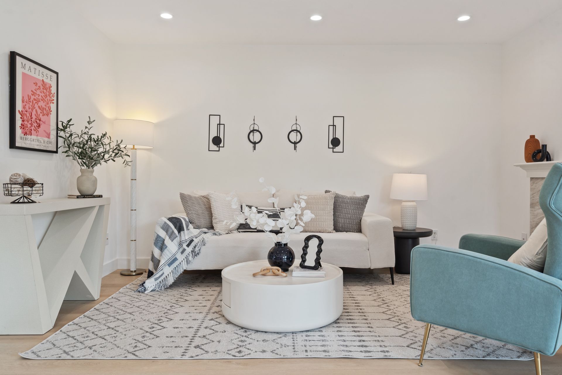 A living room with a couch , chair , coffee table and fireplace.