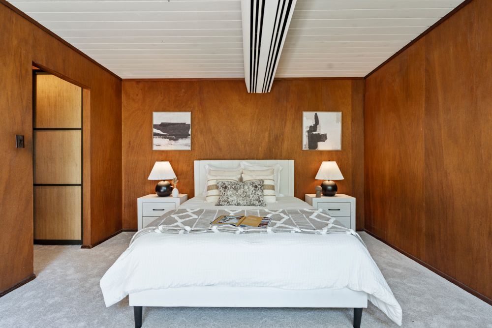 Calm primary bedroom with patio views, dual closets, and ensuite bath — Rumana Jabeen & Associates emphasize comfort for buyers and marketing strength for sellers
