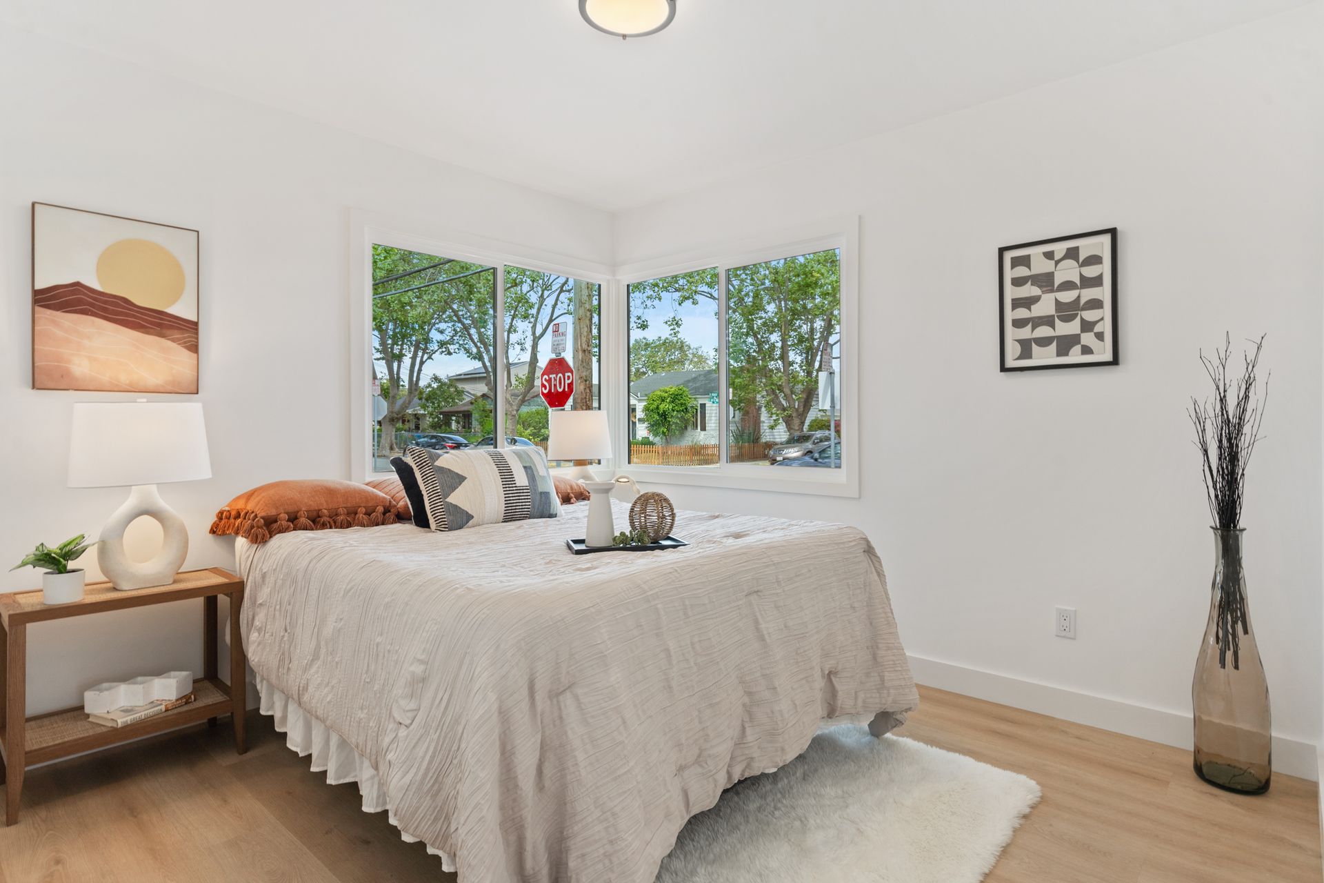 A bedroom with a bed , nightstand , and window.