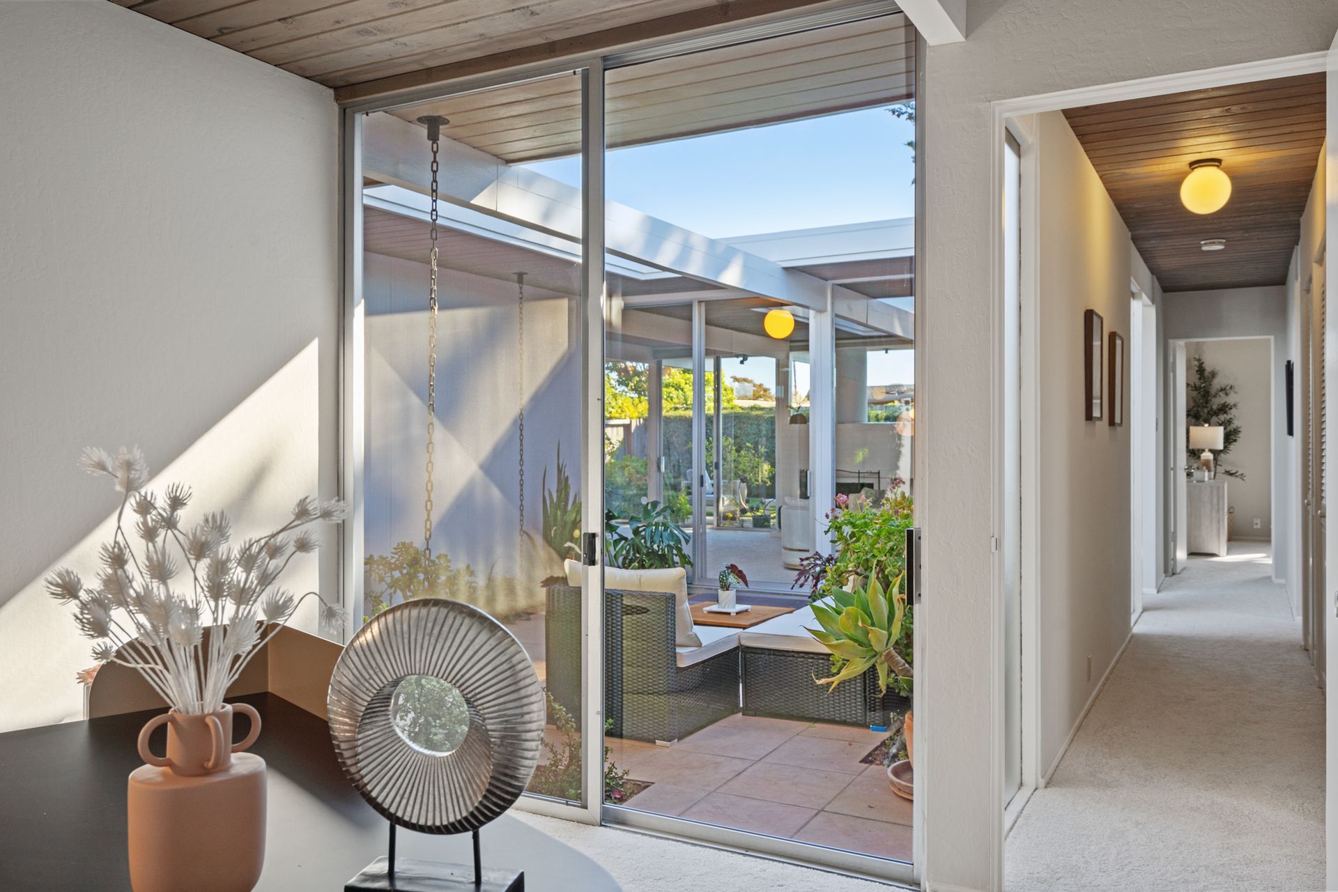 A living room with a sliding glass door leading to a patio