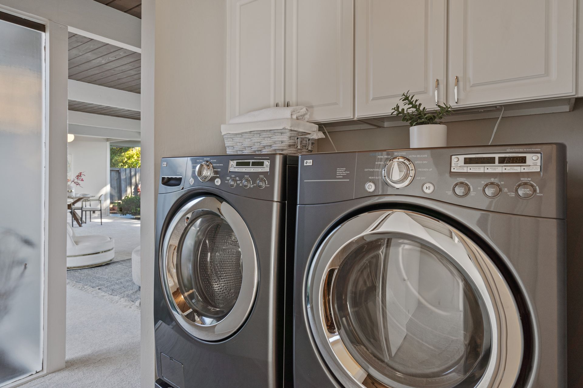 A washer and dryer are sitting next to each other in a laundry room.