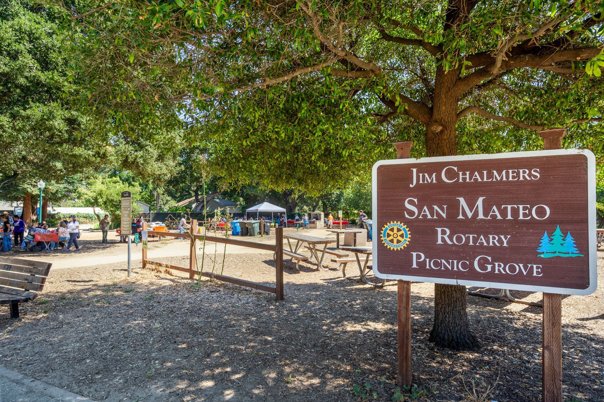 A sign for jim chalmers san mateo rotary picnic grove