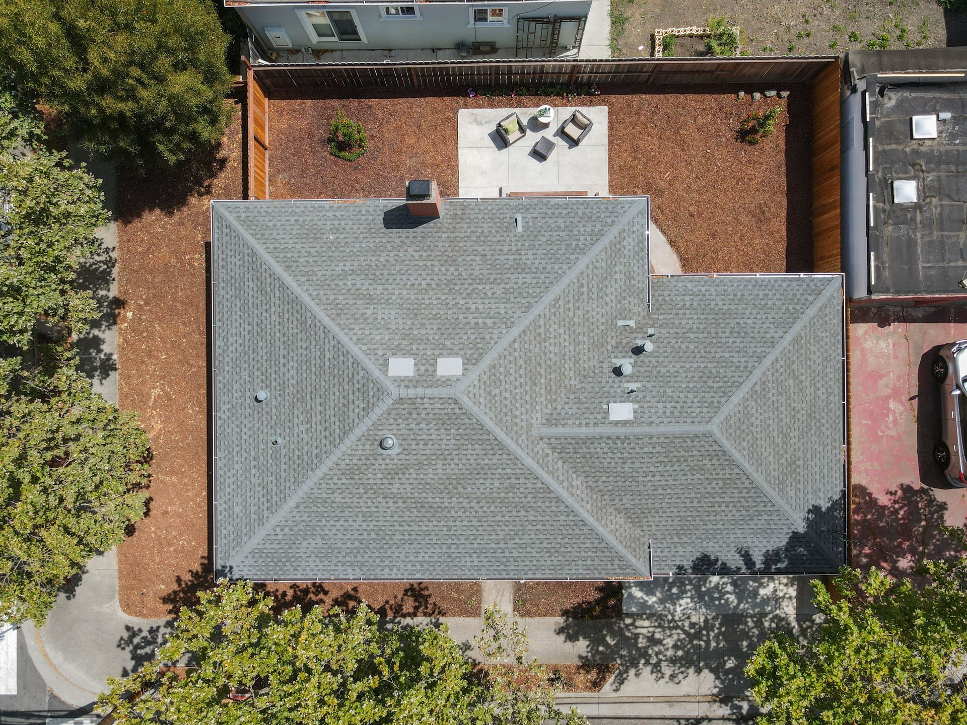 An aerial view of a house with a large roof