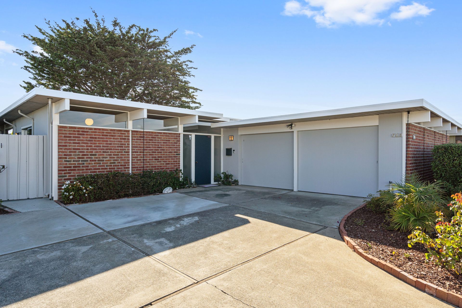 The front of a house with two garages and a driveway.