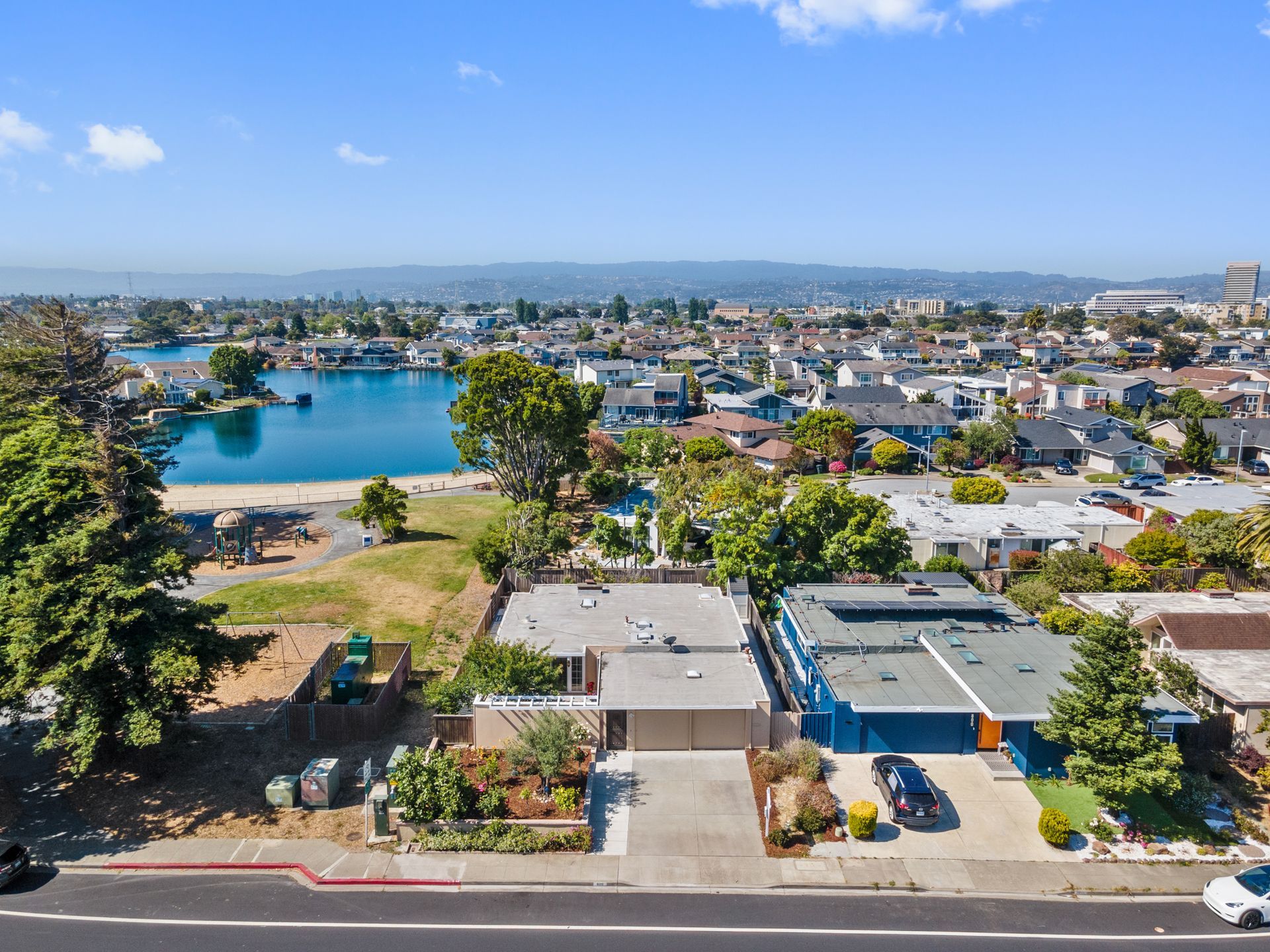 An aerial view of a house with a lake in the background