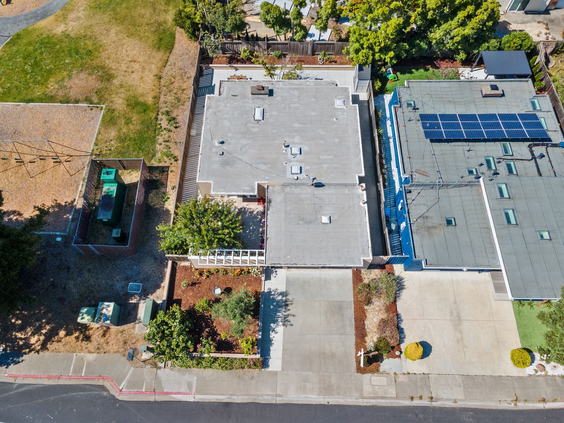 An aerial view of a house with solar panels on the roof