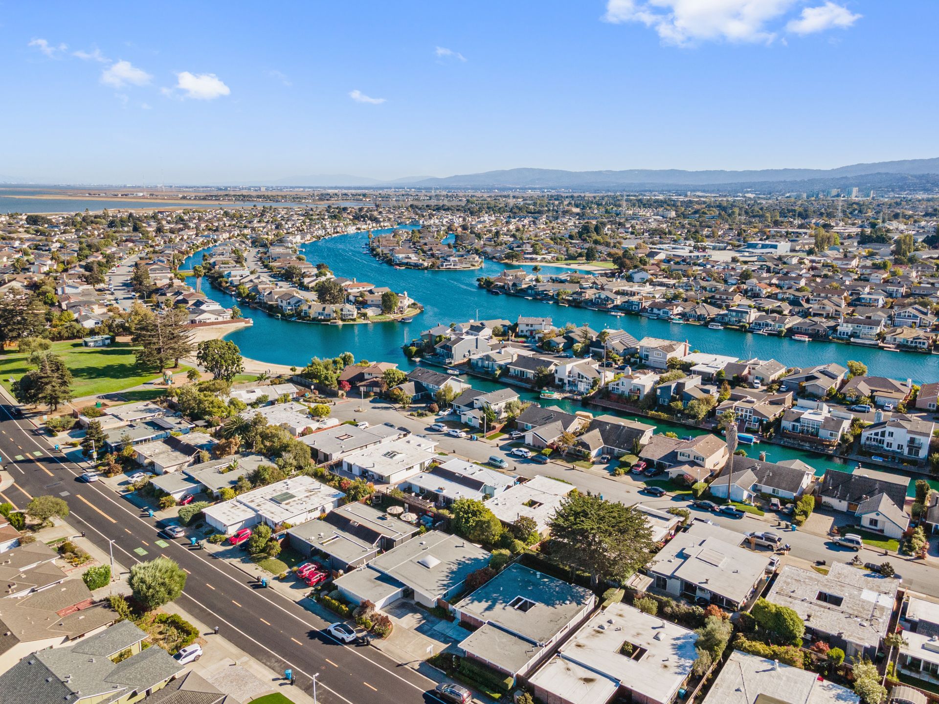 An aerial view of a residential area with a river running through it.