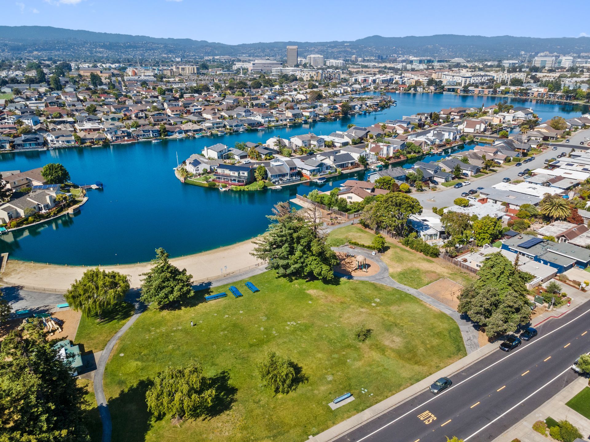 An aerial view of a lake surrounded by houses and trees