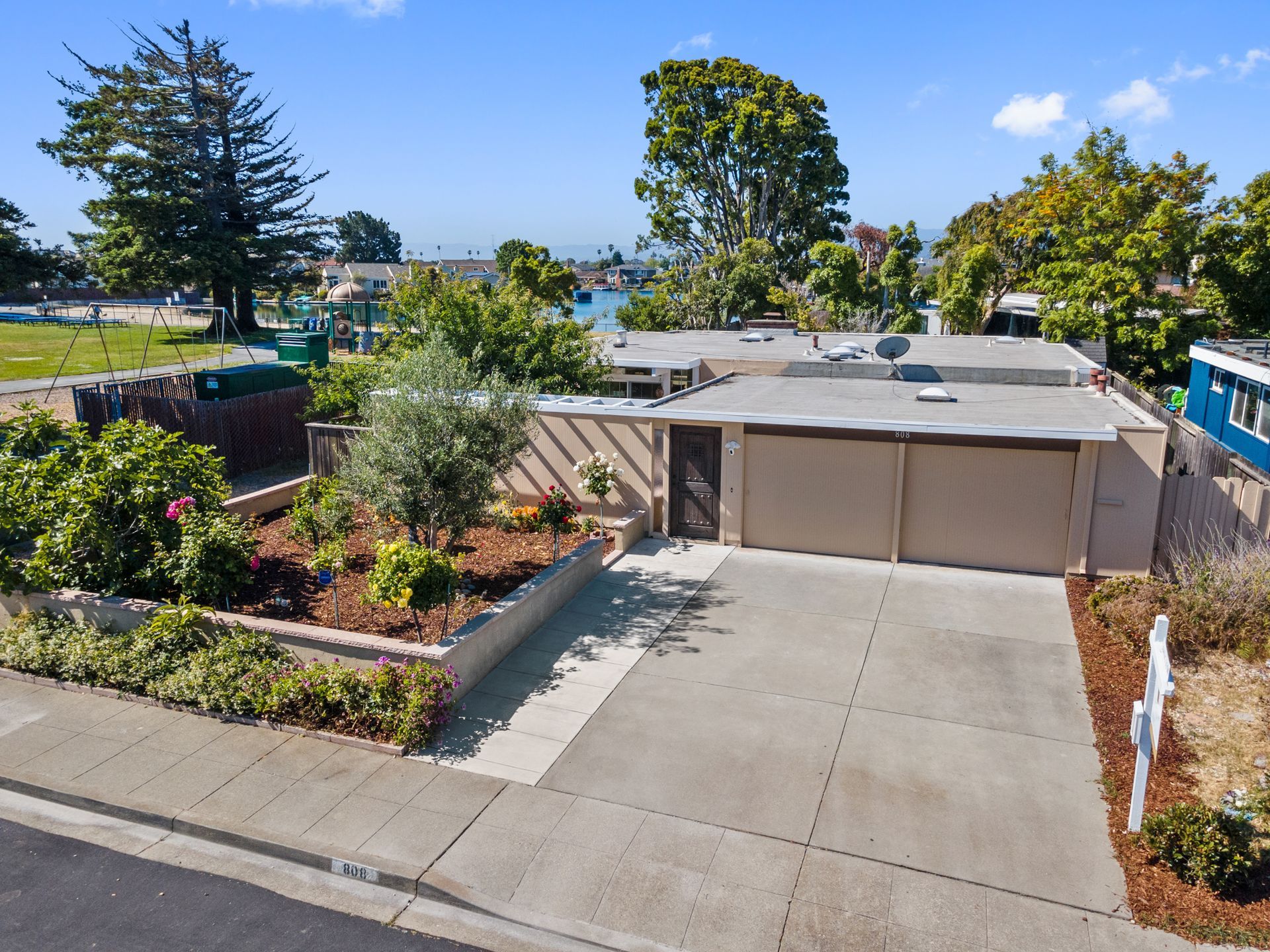 An aerial view of a house with a large driveway