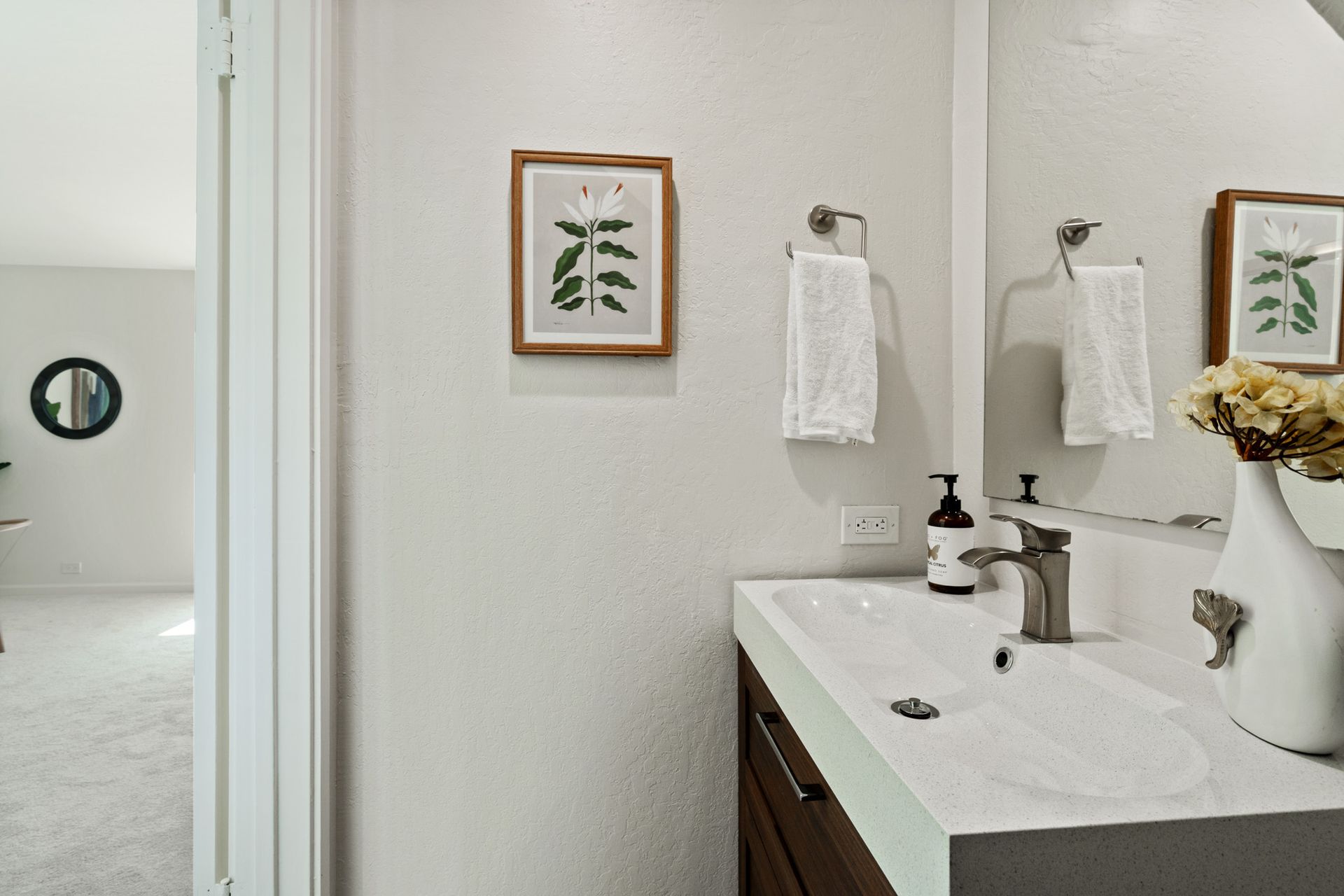 A bathroom with a sink and a mirror.