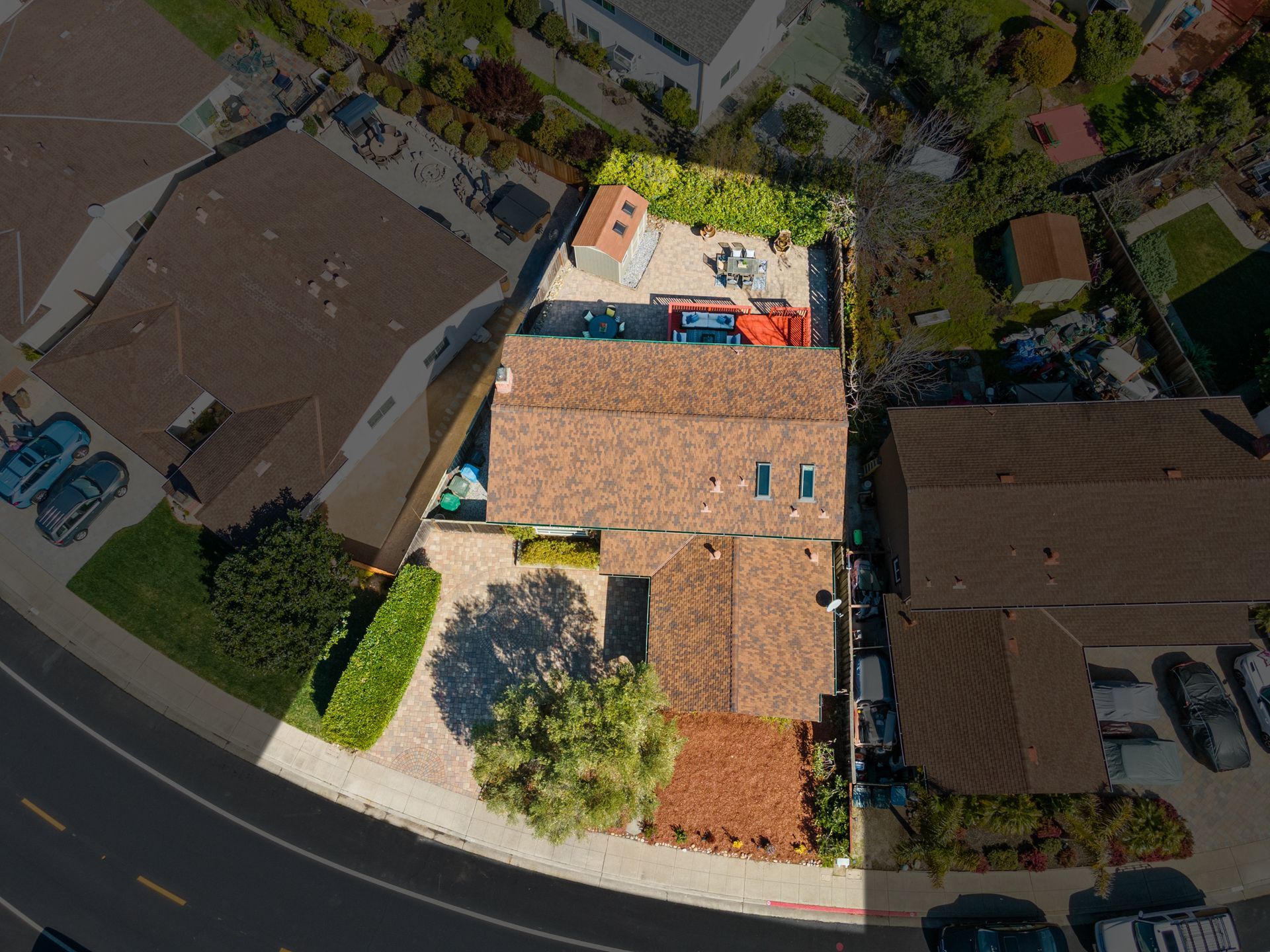An aerial view of a house with a lot of cars parked in front of it