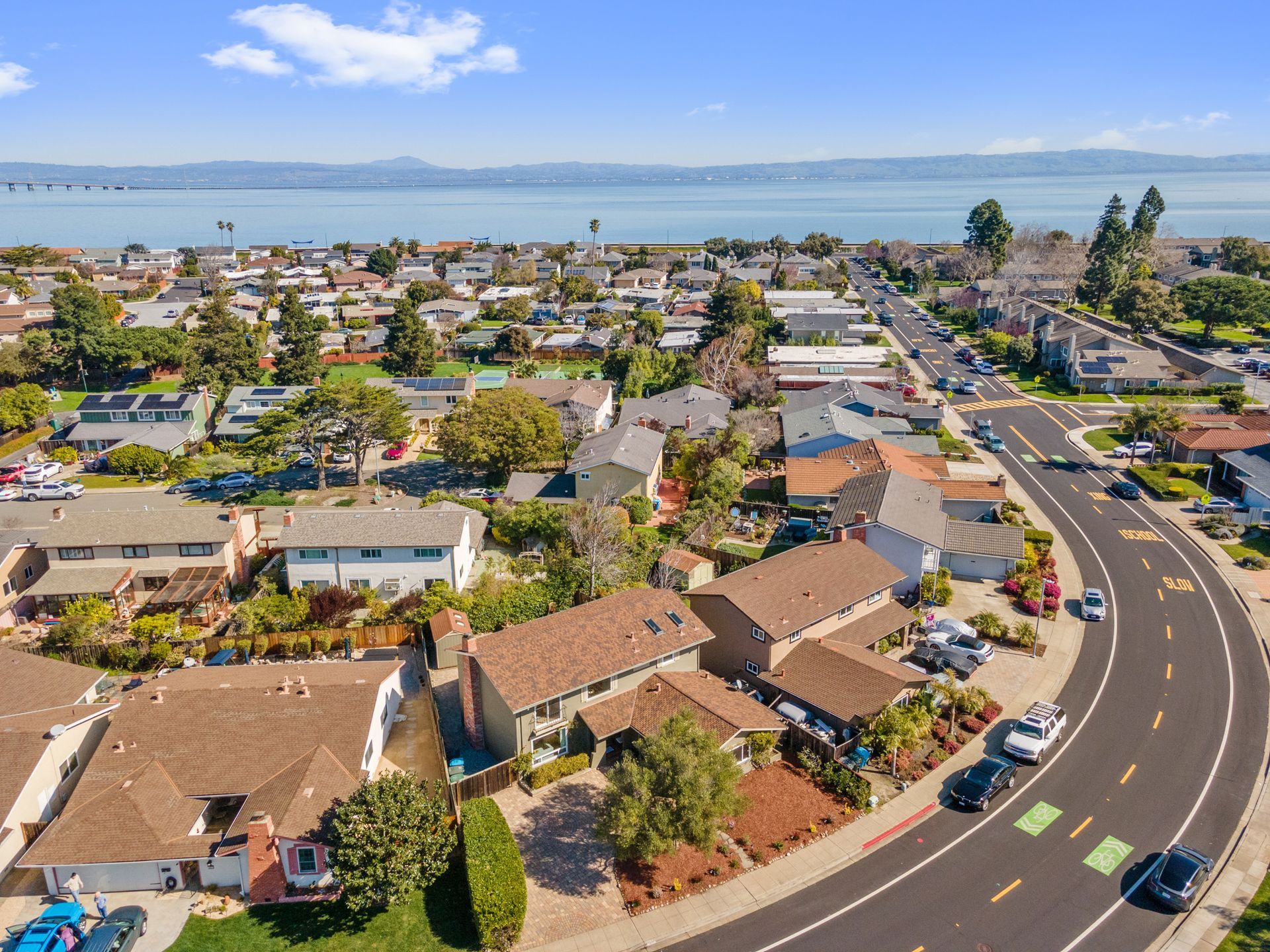An aerial view of a residential area with a lake in the background