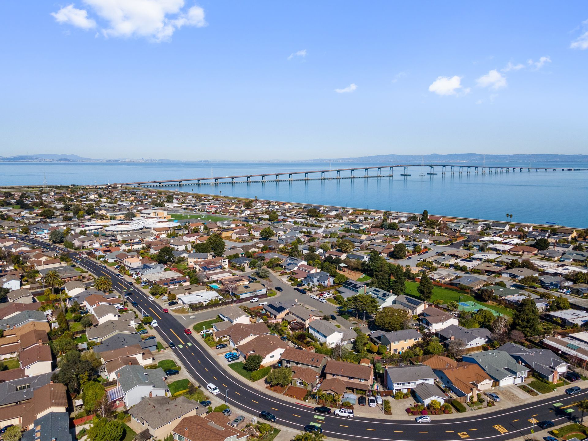 An aerial view of a residential area next to a body of water.