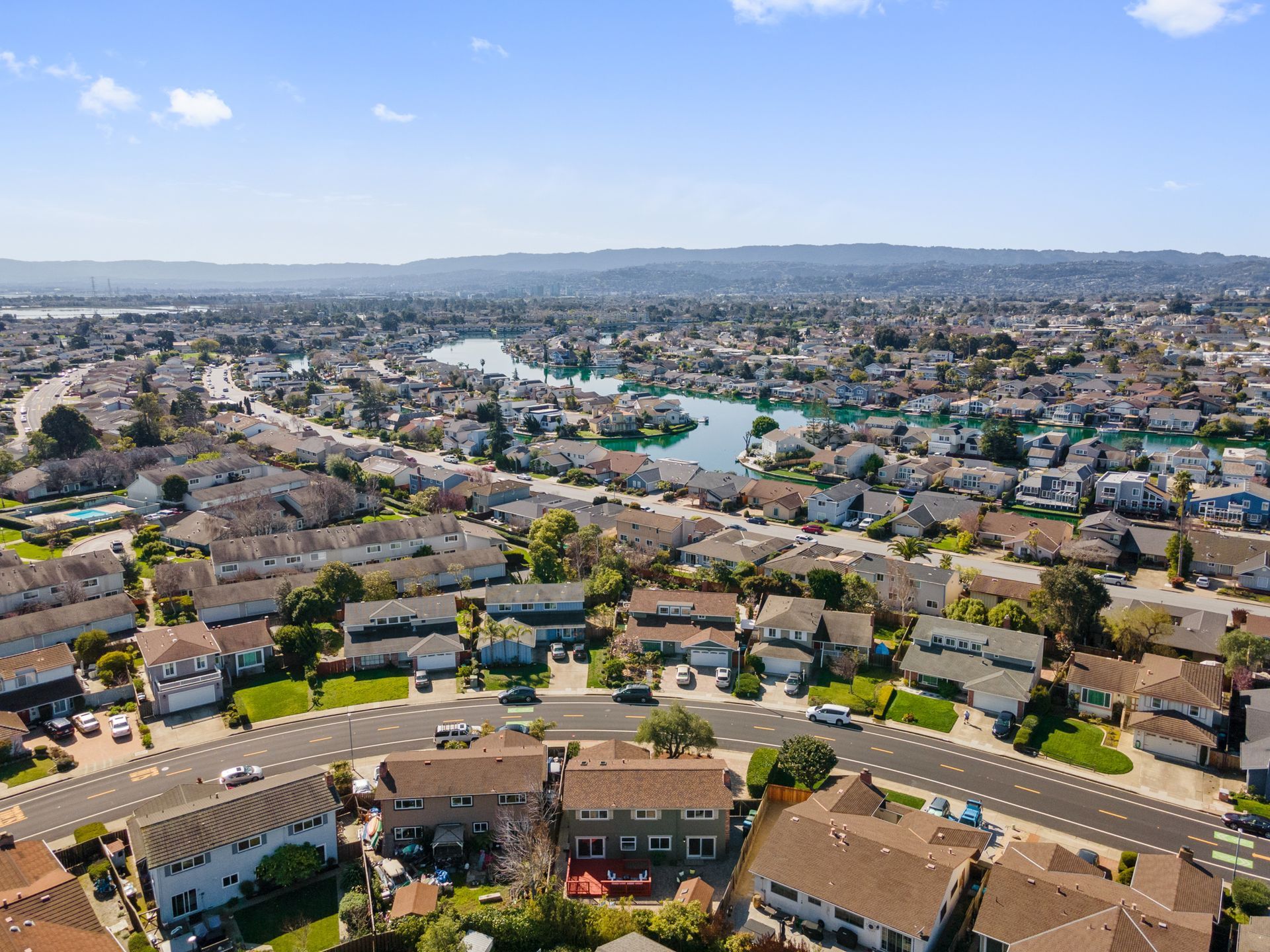 An aerial view of a residential area with a river running through it.